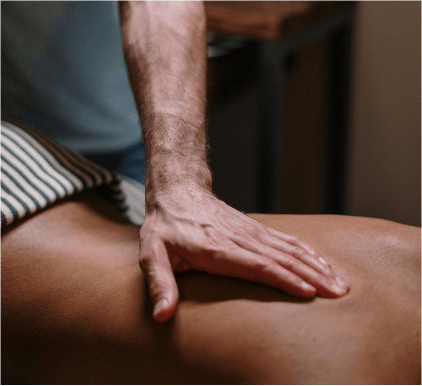 A hand applying pressure on a person's back.