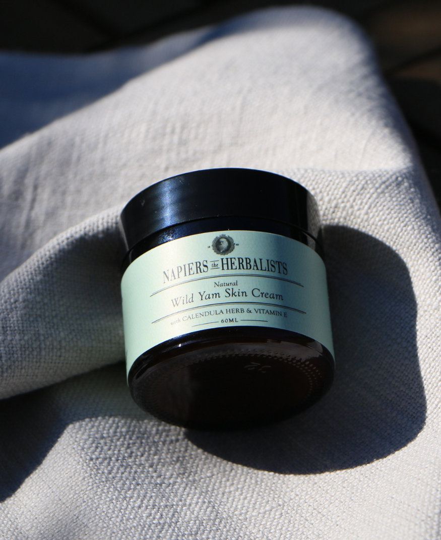 A jar of Napiers the Herbalists Wild Yam Skin Cream sitting on a grey cloth in the sun.