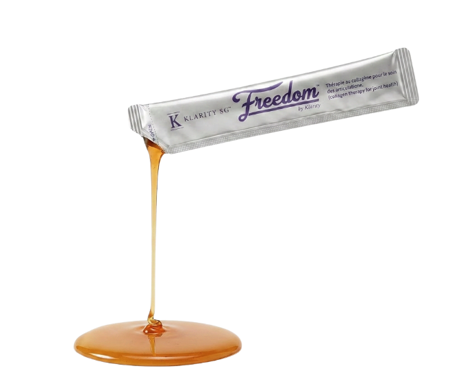A silver packet of Klarity SG Freedom collagen therapy pouring a honey-like liquid onto a white surface.