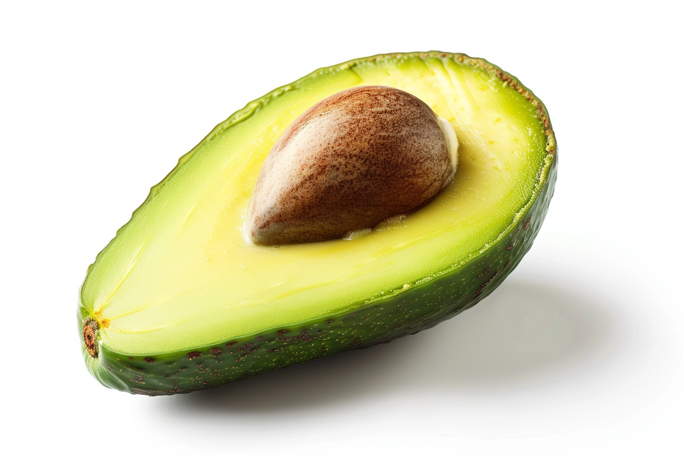 Half of a ripe avocado with a visible seed on white background.