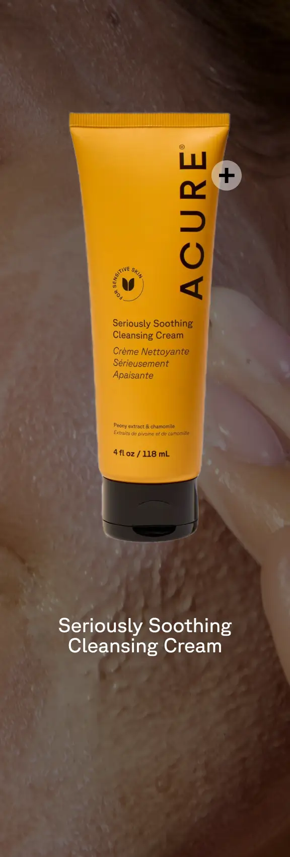 Seriously Soothing Cleansing Cream packaging with a plus sign. The background is a person applying product.