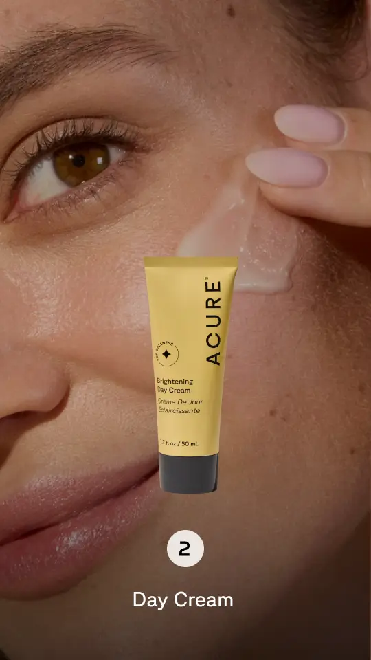 Background of person applying serum,  product image in foreground. Step 2 Day Cream
