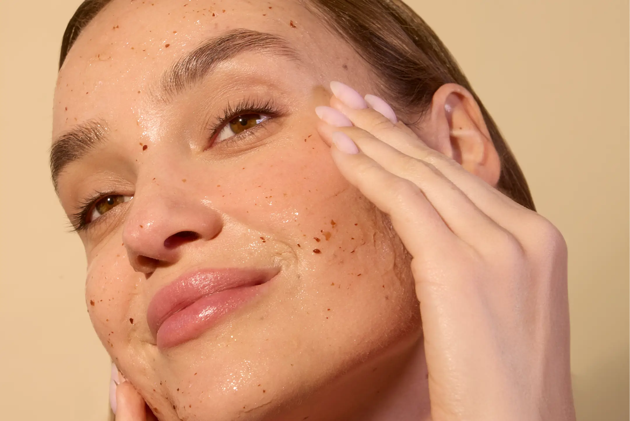 Person applying clear face mask to their face