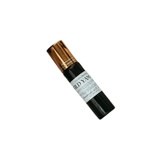 A dark glass roller bottle with a shiny copper-colored cap and a white label reading 'WILD YAM'.