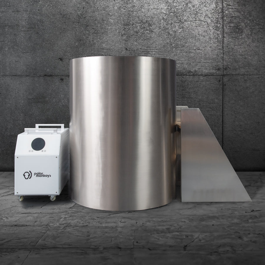 Silver cylindrical ice bath with adjacent equipment in an industrial setting.