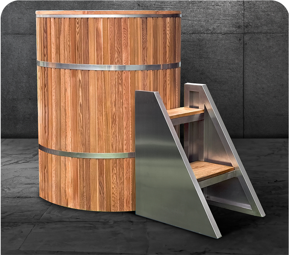 Wooden cold plunge tub with metal bands and attached metal steps on a dark floor.