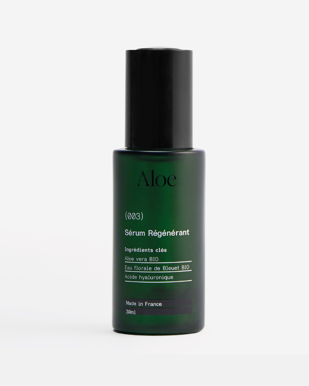 A green bottle labeled 'Aloe Sérum Régénérant' with a black cap.