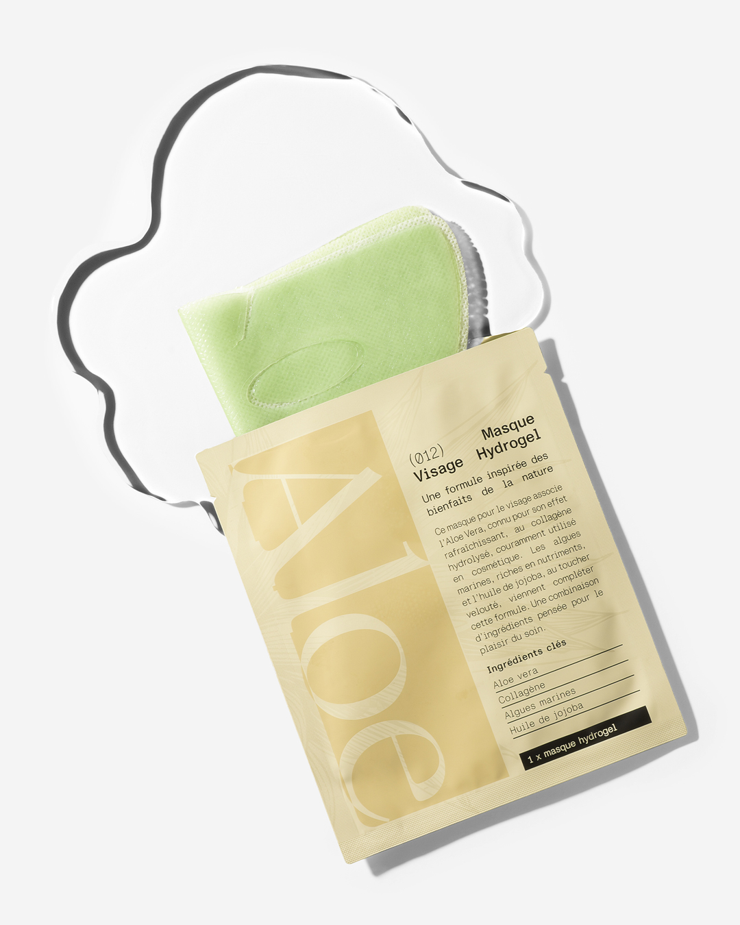 A packaged green hydrogel facial mask with visible text, lying on a reflective surface.