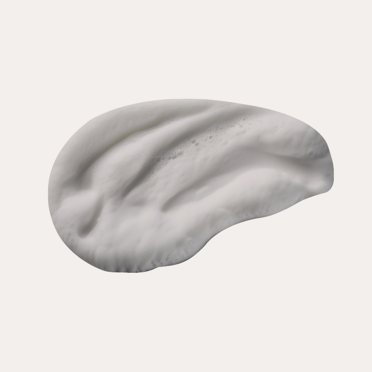 White creamy substance with a smooth texture on a plain background.