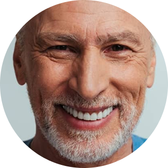 Smiling older man with short white hair and beard.