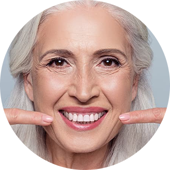 Old woman smiling and pointing at her smile