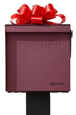Maroon mailbox with a red bow on top, labeled 'mail' and 'adoorn.'