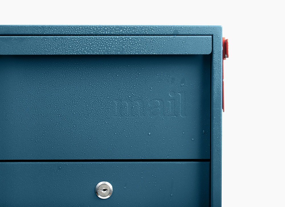 Close-up of a blue mailbox with water droplets on its surface.
