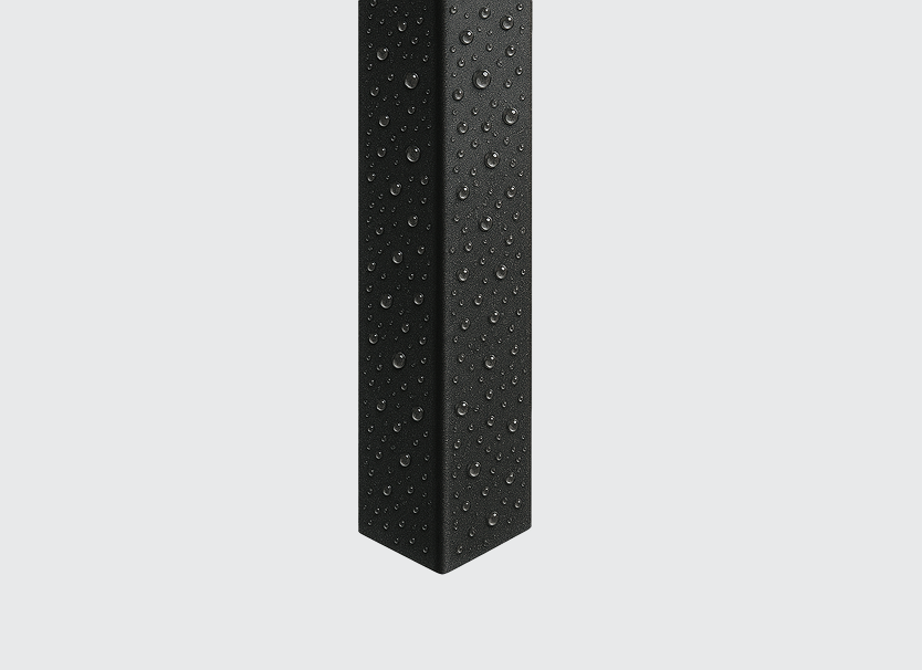 Black rectangular object with water droplets on its surface.