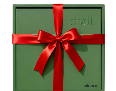 Green box with 'mail' embossed, wrapped in a red ribbon bow.