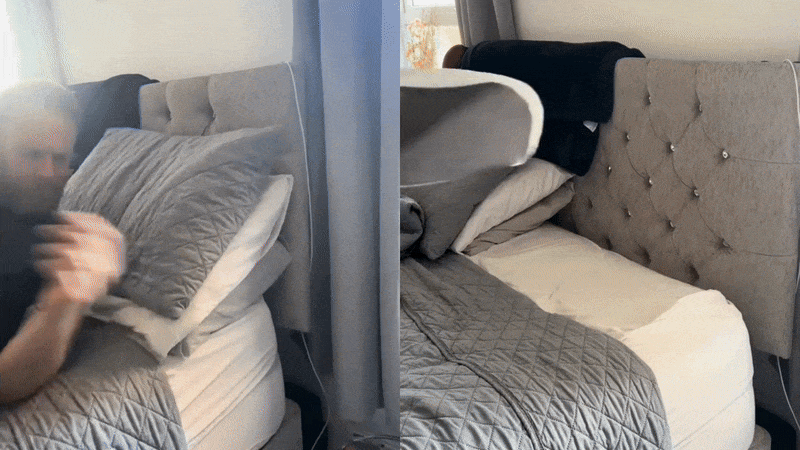 A person quickly making a bed with gray bedding.