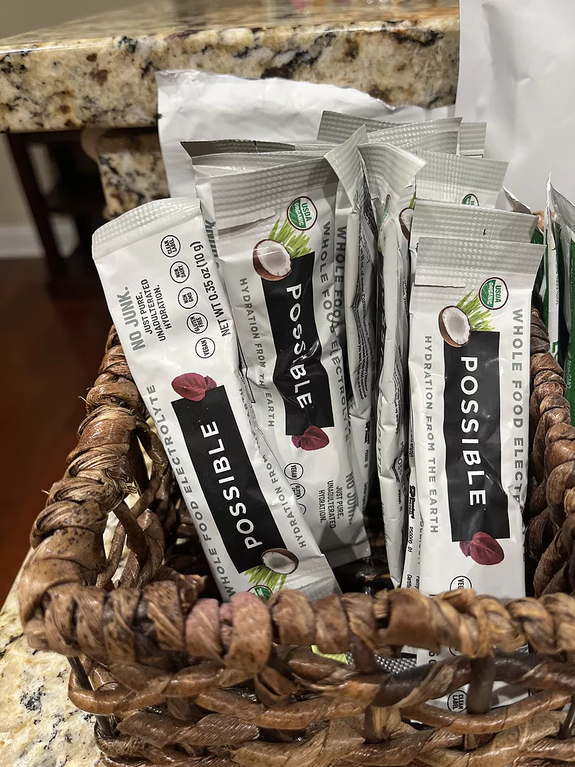 Basket with packets labeled 'Possible' on a granite countertop.