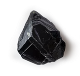 A shiny, black, irregularly shaped rock on a white background.