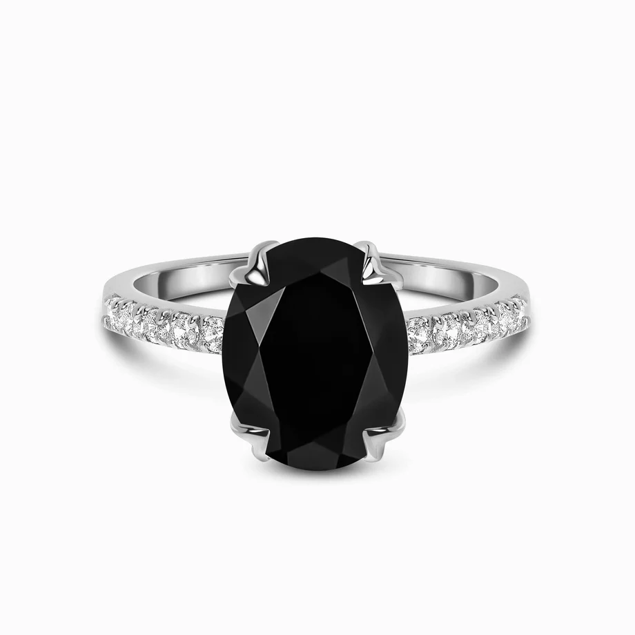 Silver ring with large black gemstone and small clear stones on the band.