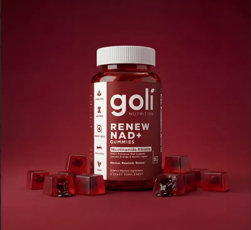 A bottle of Goli Renew NAD+ Gummies is surrounded by individual red, cube-shaped gummies on a red background.