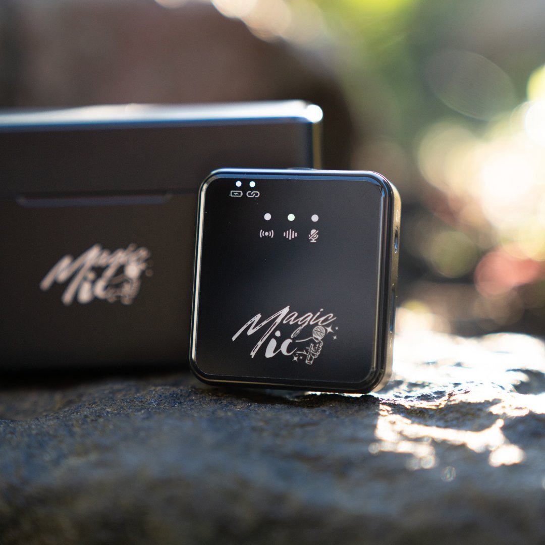 A close-up of a portable 'Magic Mic' wireless microphone system outdoors.
