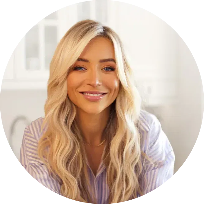 A circular portrait of a smiling woman with long blonde hair, wearing a striped shirt indoors.