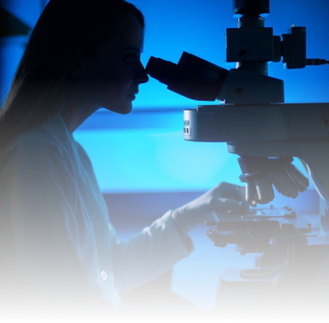 A silhouette of a scientist looking into a microscope against a blue background.