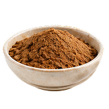 A small, off-white ceramic bowl filled with a mound of brown powder against a white background.