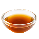A small, clear glass bowl filled with an amber-colored liquid, shown against a white background.