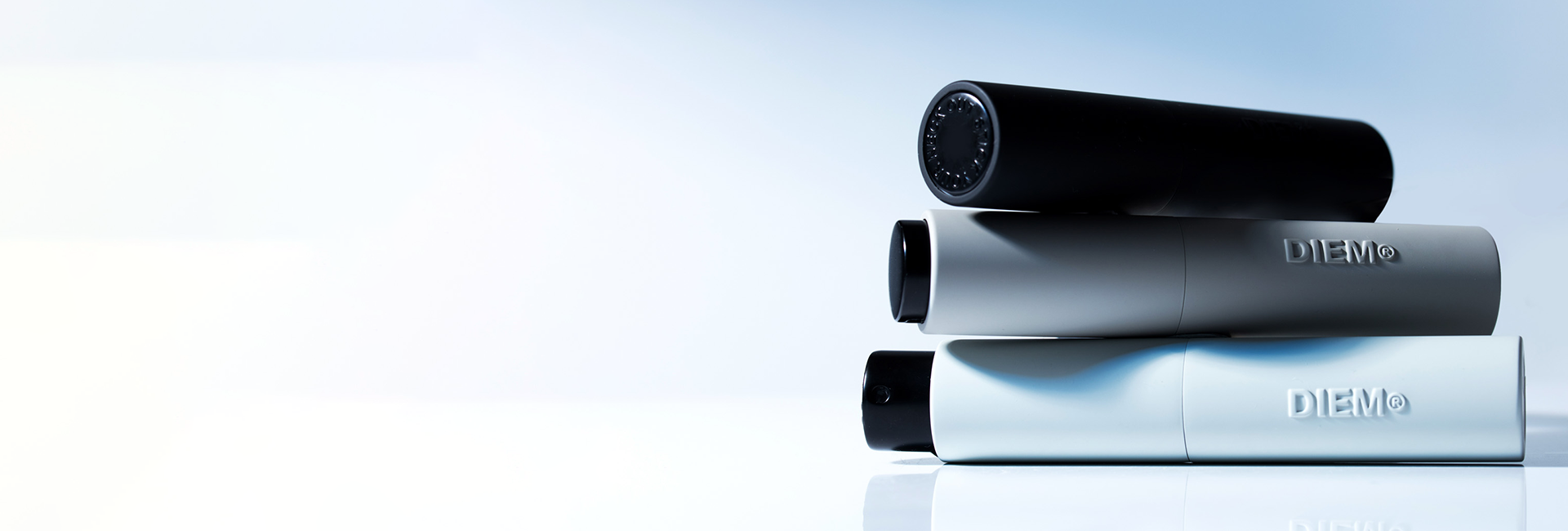Three stacked cylindrical containers with 'DIEM' branding on a reflective surface.