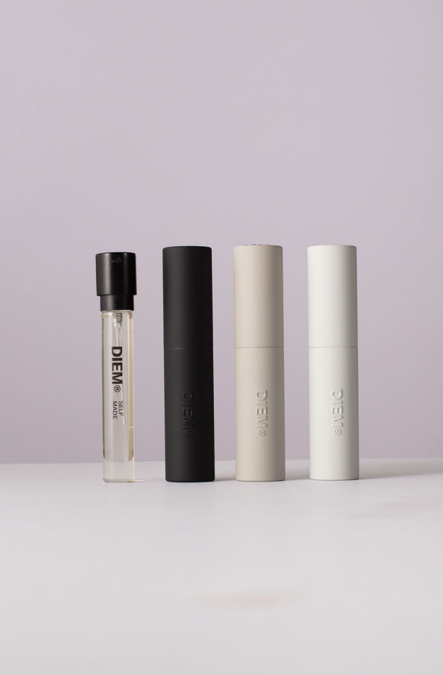 Four DIEM fragrance bottles on a plain background.