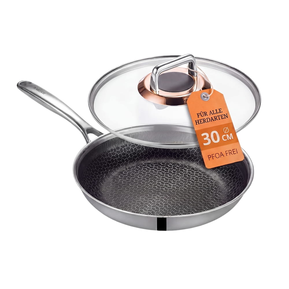 A stainless steel frying pan with a honeycomb-patterned non-stick surface and a clear glass lid.