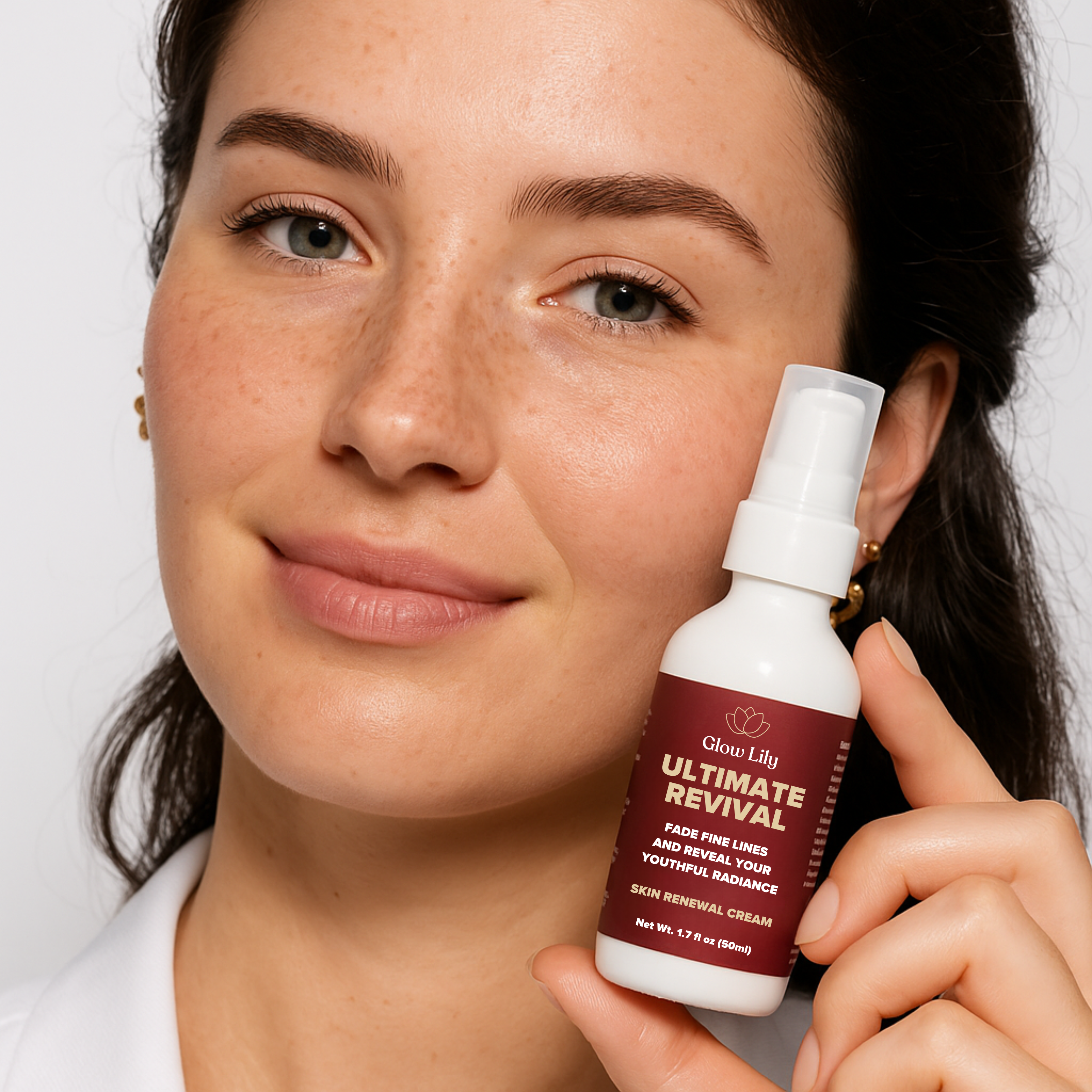 Person holding a bottle of 'Ultimate Revival' skin renewal cream.