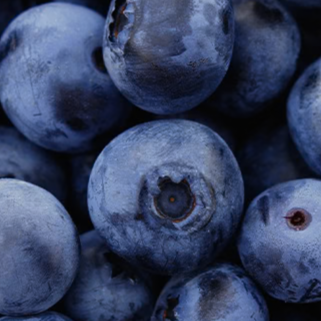 A close-up photograph of a pile of fresh blueberries.