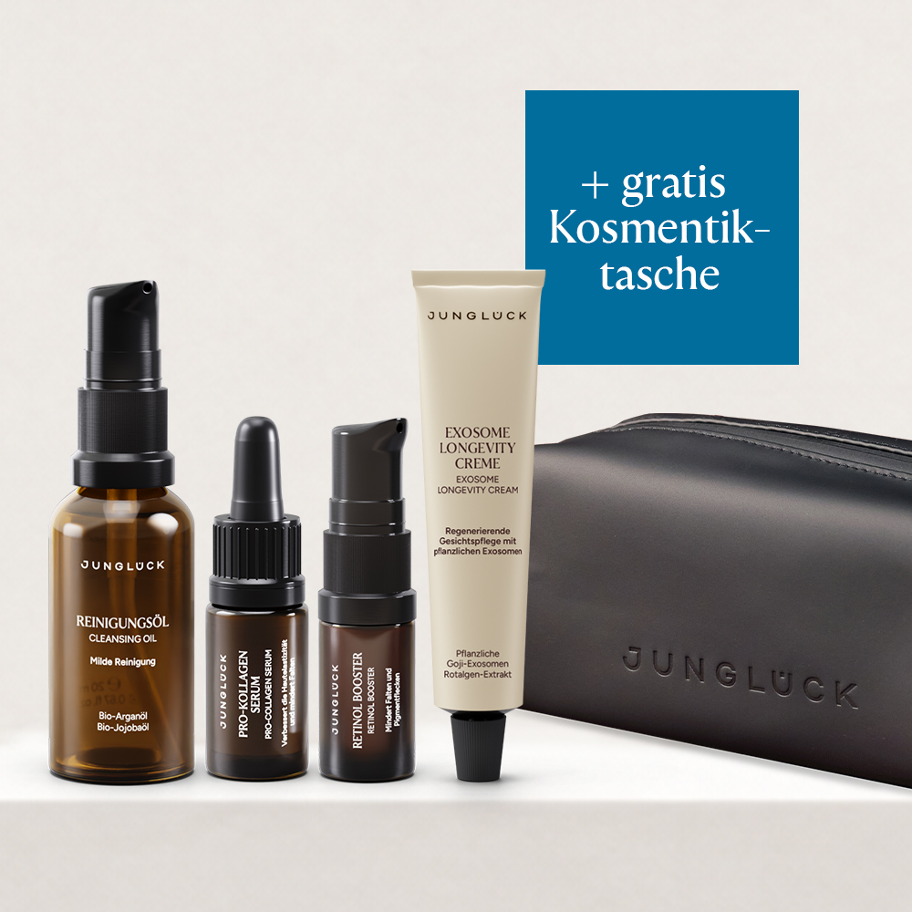 Four Junglück skincare products, including oils, a serum, and a cream, with a black cosmetics bag.