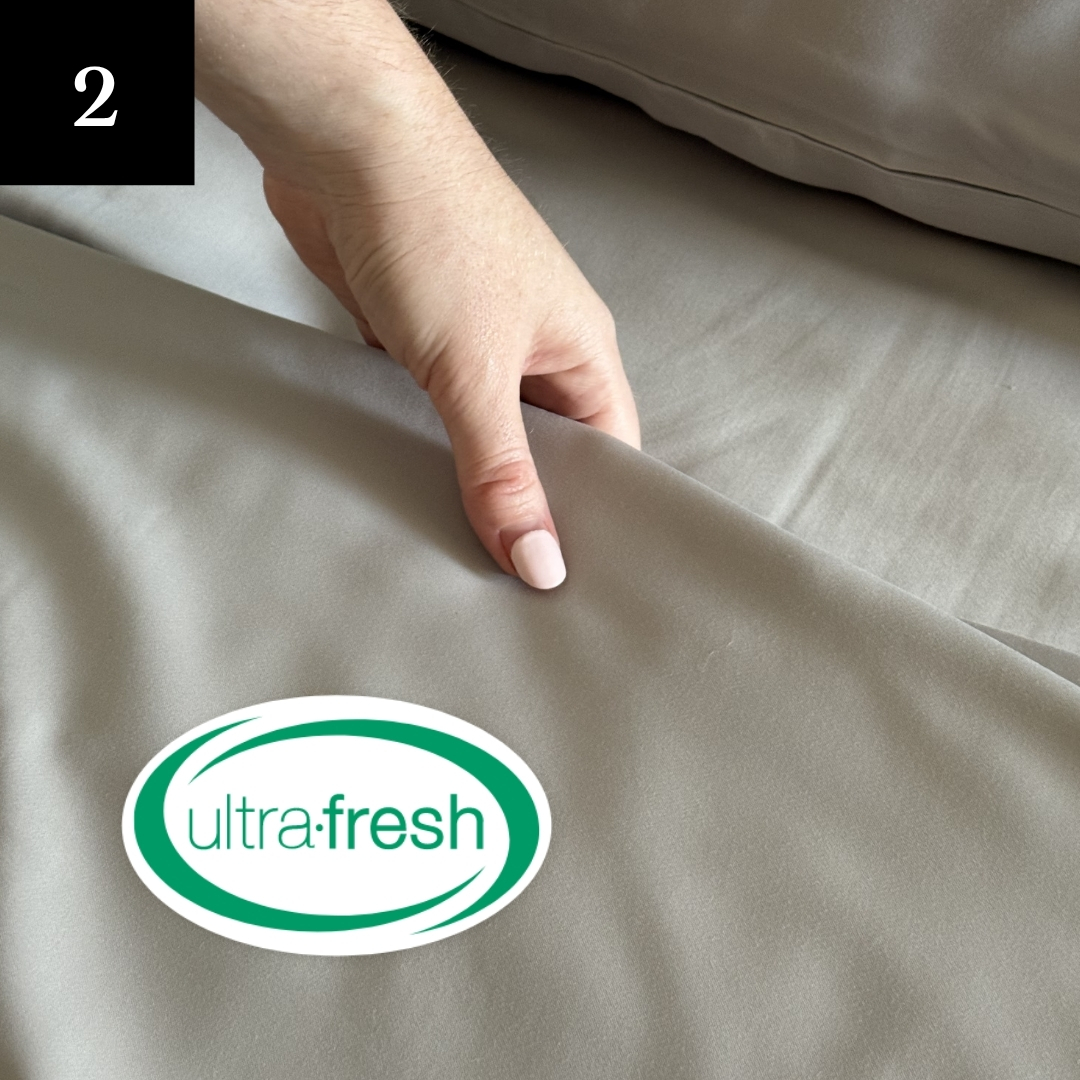 A close-up of a hand with light pink nails holding a gray sheet with an 'ultra-fresh' logo.