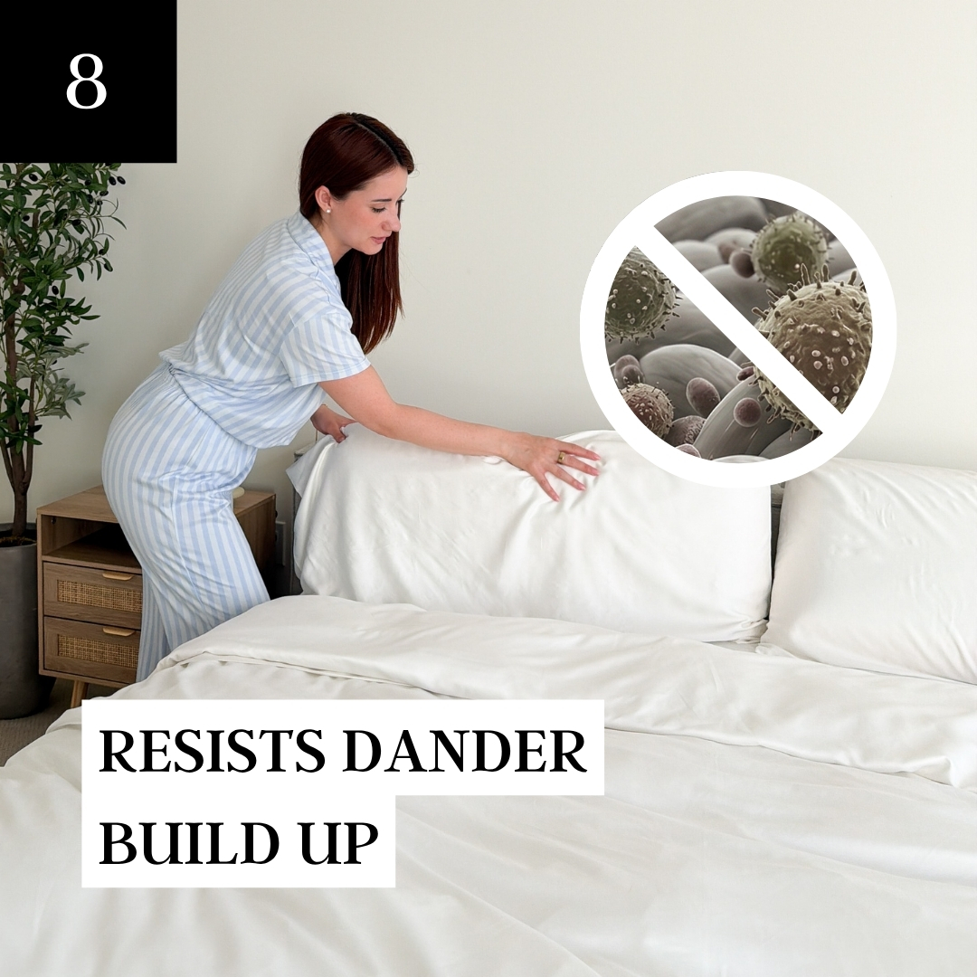 A woman in pajamas makes a bed with white linens, with a graphic showing dander resistance.