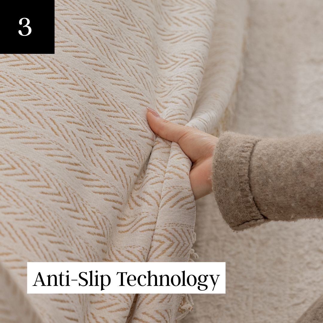 A close-up of a hand holding a cream-colored fabric with a tan chevron pattern.