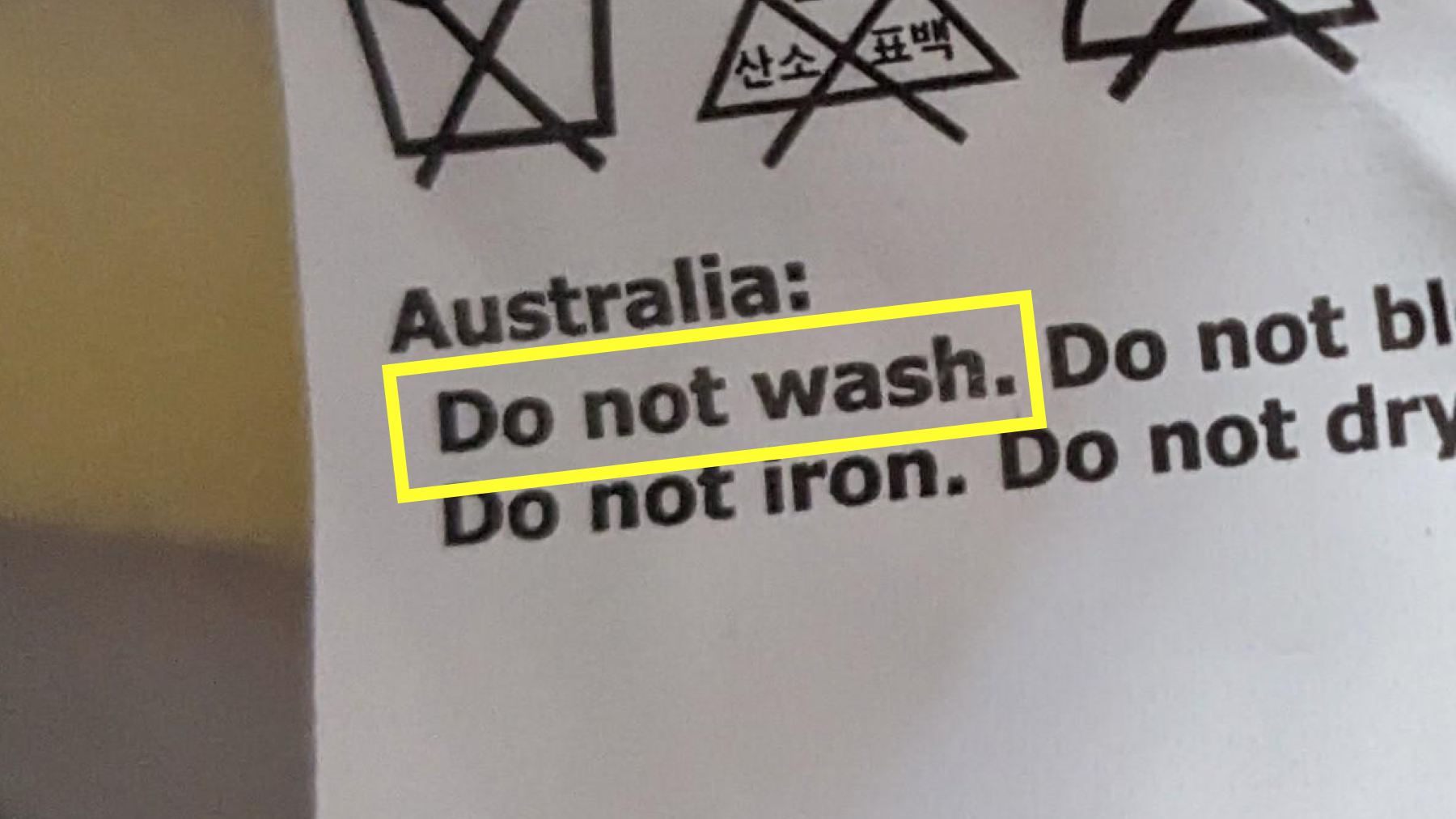 Clothing label with washing instructions, 'Do not wash,' marked with a highlight.