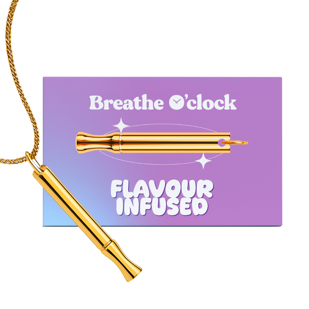 A gold-colored breathing tool on a chain necklace, shown with its purple and blue packaging card.