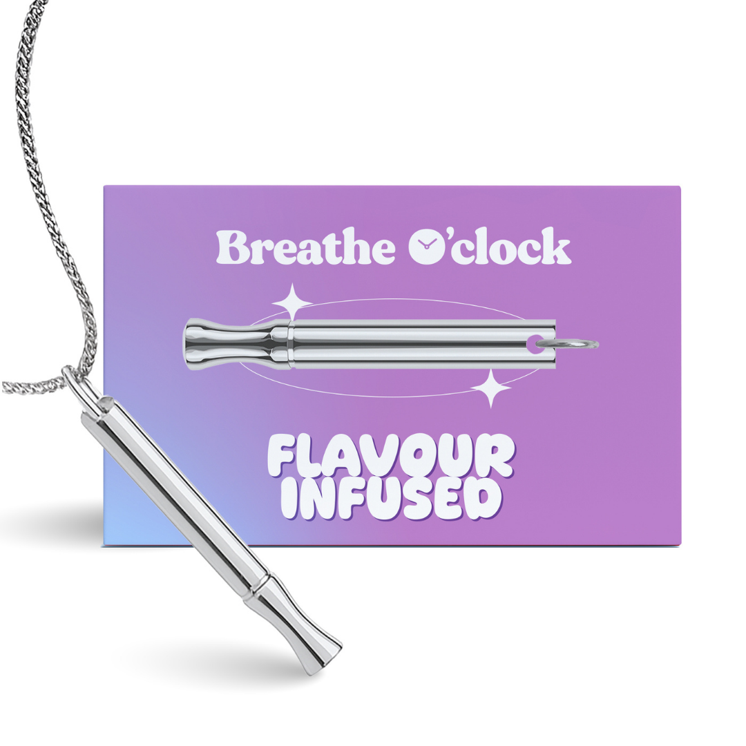 A silver whistle-like pendant on a chain, resting against its purple packaging card labelled 'Breathe O'clock'.
