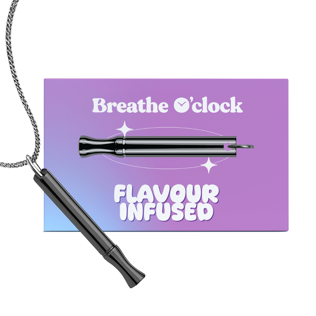 A black whistle-shaped pendant on a silver chain, in front of its purple 'Breathe O'clock' packaging card.