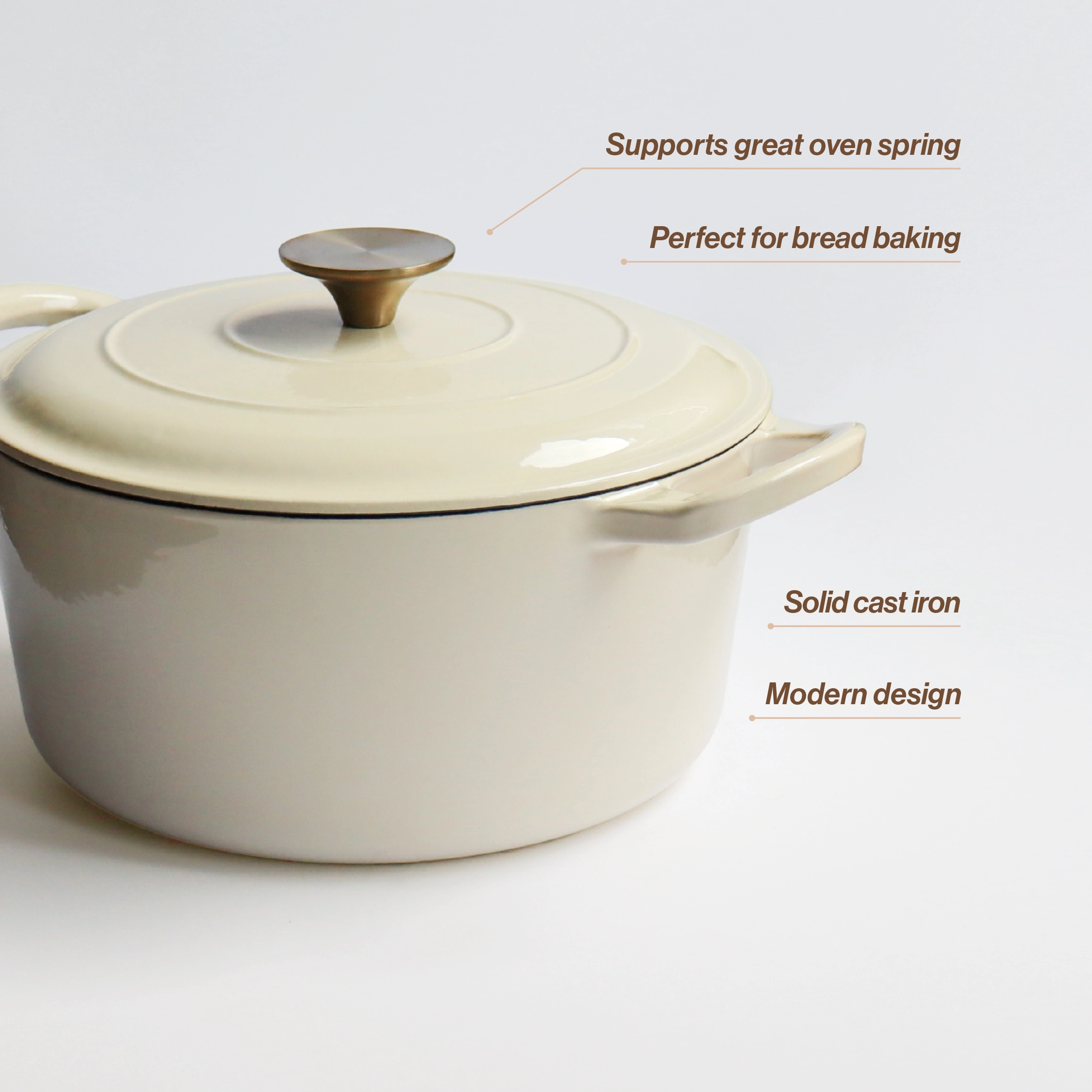 A cream-colored cast iron Dutch oven with a lid and gold knob, against a white background.