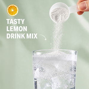 A hand pours a scoop of lemon drink mix powder into a glass of sparkling water with ice.