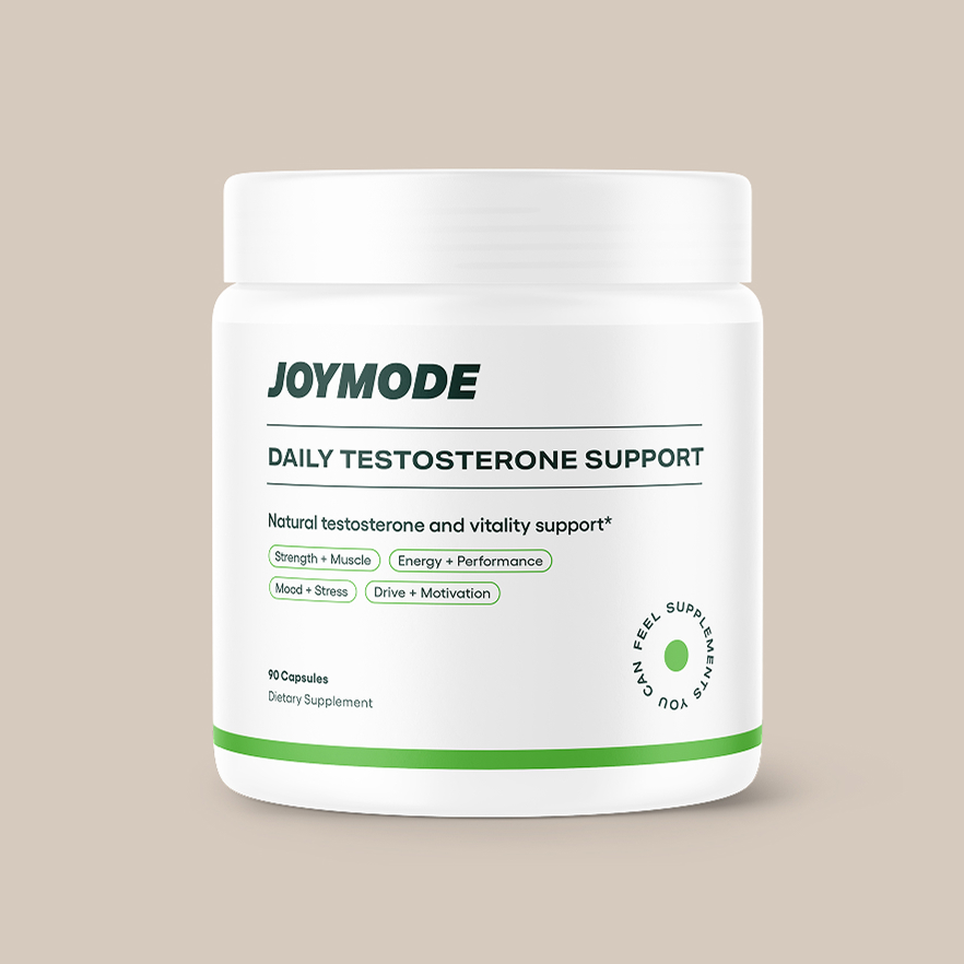 A white bottle of Joymode Daily Testosterone Support supplements against a light brown background.