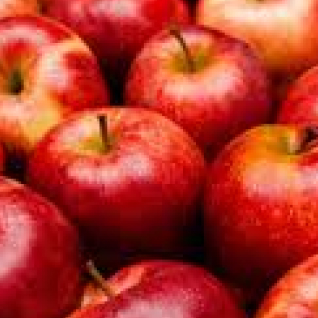 A pile of fresh, vibrant red apples closely packed together.