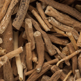 Close-up of dried brown herbal roots and twigs piled together.