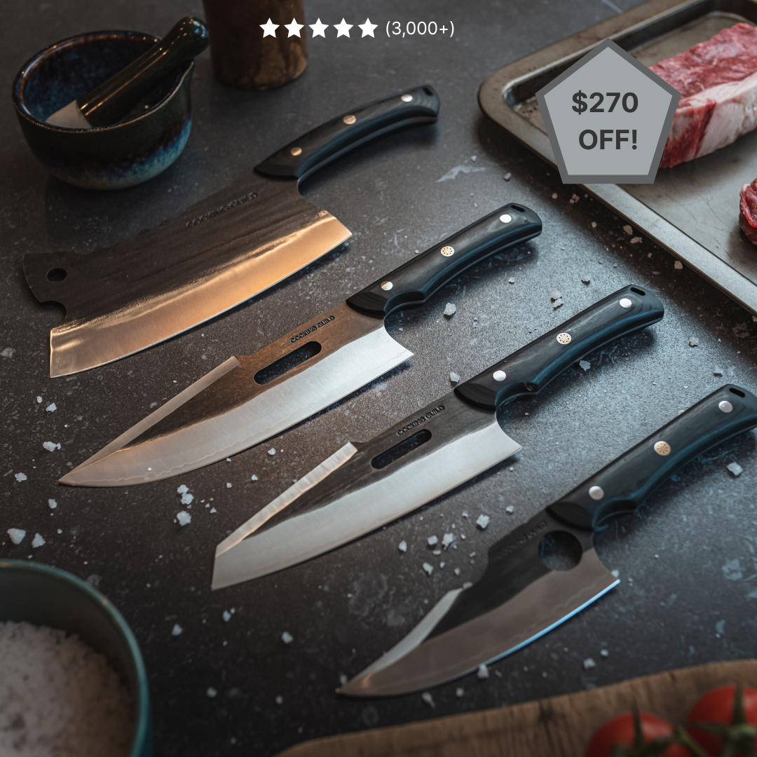 Set of five kitchen knives on a dark countertop with salt and a meat tray.