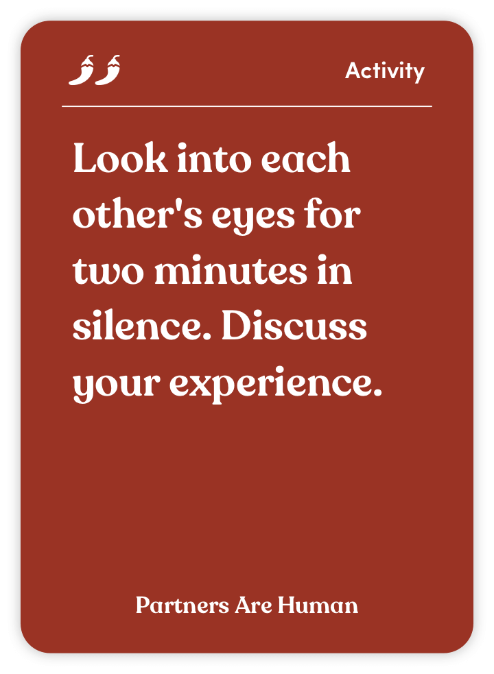 Card with text: 'Look into each other's eyes for two minutes in silence. Discuss your experience.'