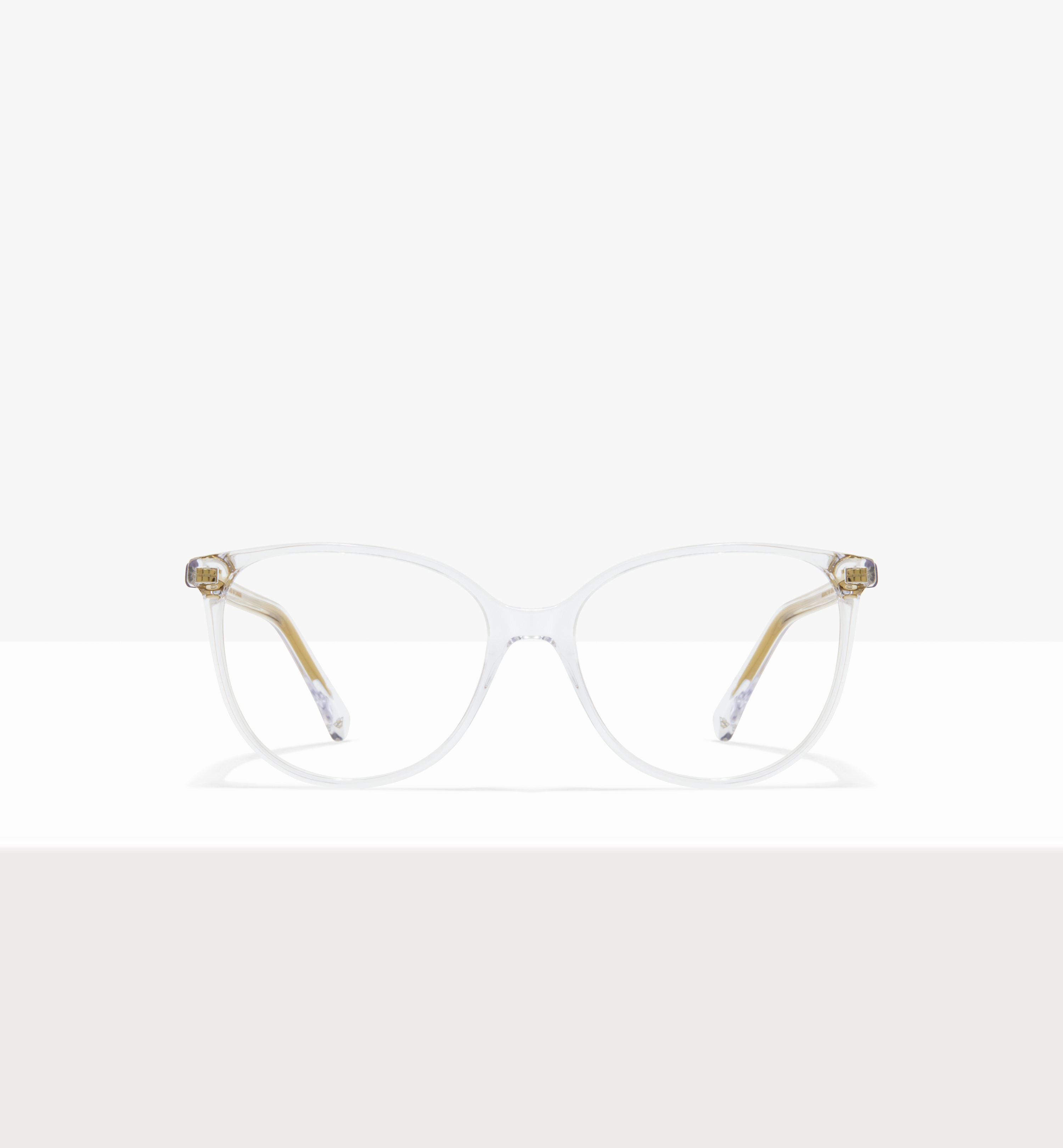 Clear eyeglasses with transparent frames and gold temples on a white background.